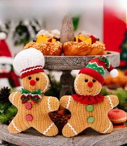 Detail of knitted gingerbread man ornaments with chef hat and Christmas tree decor