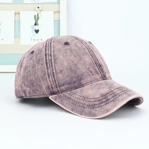 Detail view of purple washed denim baseball cap with vintage distressed texture and stitching