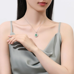 Elegant S925 silver necklace with oval emerald green gemstone and halo diamonds on model