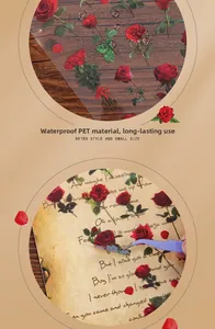 Waterproof PET red rose stickers being applied to a vintage letter using tweezers
