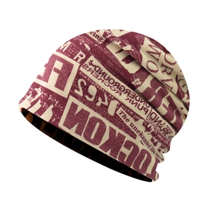 Detail of street style beanie with red newspaper print and underground rock lettering