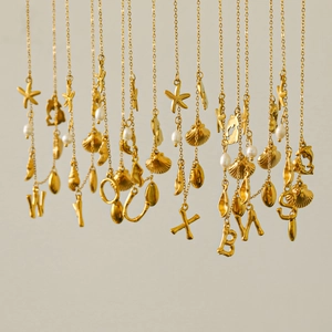 18k gold plated sea star necklaces featuring freshwater pearls and initial pendants