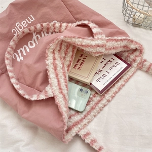 Detail view of pink canvas tote with sherpa trim showing spacious interior capacity