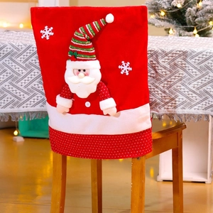 Close-up of Santa Claus chair cover with 3D design on a wooden chair in a festive setting