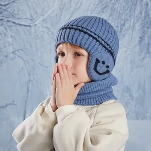 Winter light blue knit hat and scarf set for boys with earflaps and smiley pattern