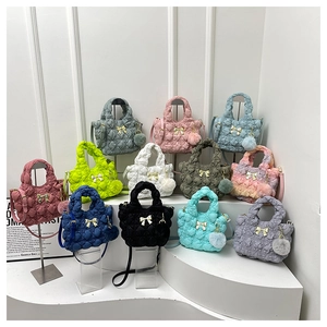 Quilted cloud handbags collection in twelve vibrant colors with gold bow and pom-pom charms