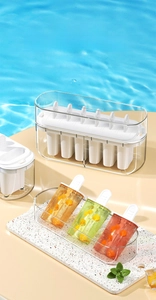 Detail of 6-cell ice pop mold with lid showing finished fruit popsicles by the pool