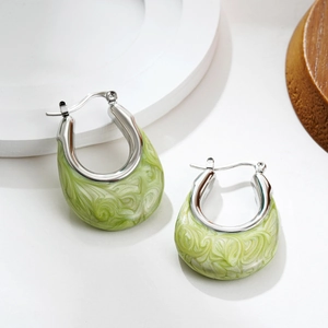 Detail of silver U-shaped hoop earrings with light green marble enamel inlays