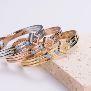 Minimalist evil eye bracelets in gold and silver with blue beads and crystals