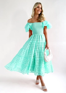 Detail of mint green off-shoulder dress with puff sleeves and layered ruffle skirt