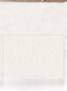 Detailed view of the modern cream carpet showing fine linear woven texture and stain-resistant fabric