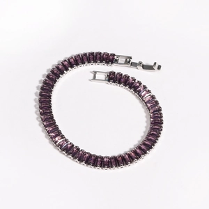 Detail of purple emerald-cut zircon tennis bracelet with silver-tone fold-over clasp