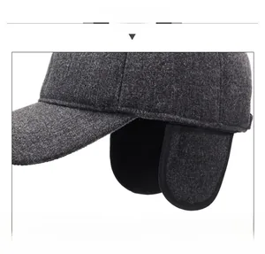 Detail of winter baseball cap showing dark grey wool fabric and black fleece ear flaps