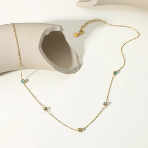 Detailed close-up of 18K gold plated S925 silver chain with blue evil eye beads