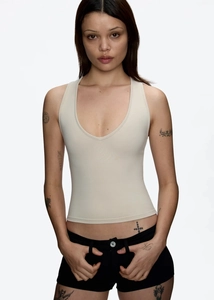 Detail view of the beige slim fit deep V-neck tank top in soft ribbed knit fabric