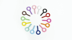 Macro view of colorful painted eyelet screws in circular arrangement for DIY crafts