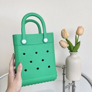 Detail shot of bright green EVA beach bag with signature perforated hole pattern