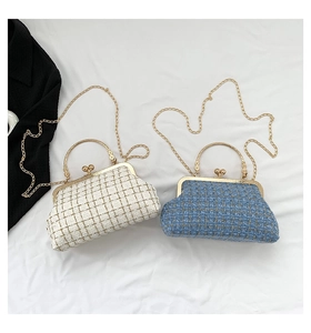 Detail of white and blue plaid tweed shell bags with gold chain and metal frame