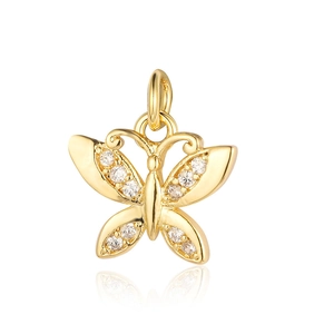 Macro shot of gold butterfly charm with sparkling zircon wings on white background