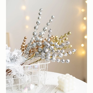 Sparkling Christmas berry branches in gold and silver for festive tree decoration