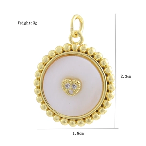 Macro view of gold-plated white shell pendant with dimensions 2.3cm by 1.8cm