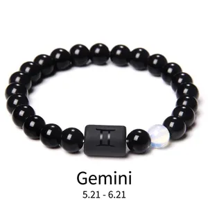 Detail of Gemini constellation bead bracelet with obsidian stones and blue accent bead