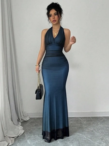Detail of elegant peacock blue halter V-neck maxi dress with pleated satin fabric texture