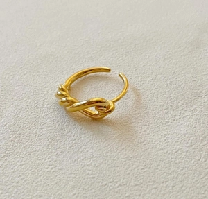Detailed view of 925 silver knot ring in warm gold with adjustable open band design