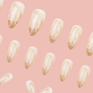 Pink almond press-on nails with golden glitter gradient and white feather patterns