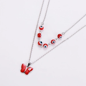 Detailed view of silver butterfly pendant and red evil eye beads on double chain necklace