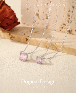 Detailed view of pink square cut gem pendants on elegant silver chain necklaces