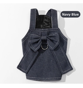 Detail view of navy blue denim dog dress featuring a large bow and metallic D-ring