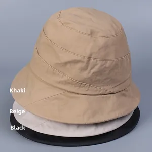 Detail view of foldable cotton bucket hats in khaki, beige, and black for summer shade