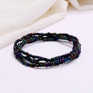 Macro detail of multi-layered colorful beaded waist chain with rainbow metallic glass beads