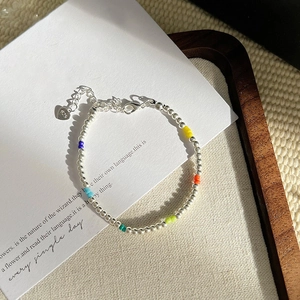 Macro shot of colorful beaded S925 silver bracelet with star charms and 925 stamp detail