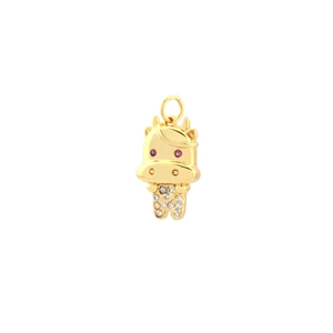 Detailed view of a gold bull pendant featuring white cubic zirconia and red gem eyes