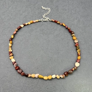 Detailed macro view of bohemian irregular natural stone chips necklace with lobster clasp