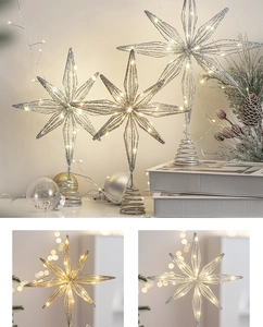 Detail of silver wire Christmas tree star topper with warm and cool LED lighting