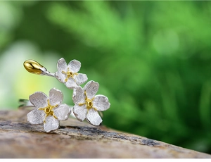 Macro detail of S925 sterling silver forget-me-not flower ring with brushed matte texture