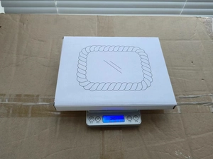 Macro view of product packaging box on electronic scale showing precise weight data