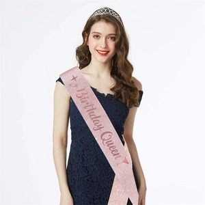 Close-up of pink glitter Birthday Queen sash and elegant sparkling rhinestone tiara set