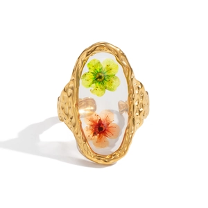 Detailed macro view of gold titanium ring with embedded dried flowers in resin