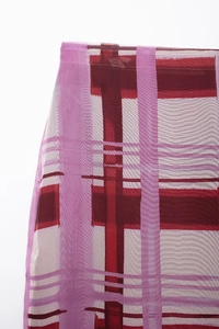 Detailed close-up of purple and dark red geometric print on sheer mesh fabric