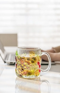Detail of hand-painted grape embossed glass mug with comfortable ergonomic handle