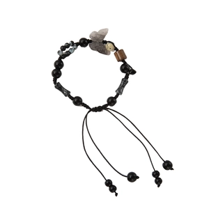 Retro ink-style beaded bracelet with black onyx and grey butterfly pendant on white background