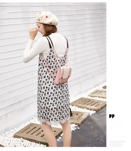 Fashionable small pink and white mini backpack shown in a stylish outdoor lifestyle setting