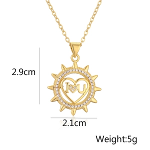 Detailed view of gold sunburst pendant with I love U heart and dimensions 2.9cm by 2.1cm