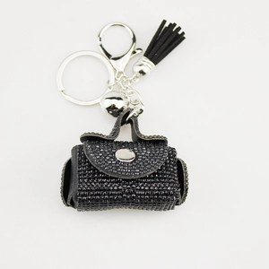 Detailed view of luxury black rhinestone mini handbag keychain with silver tassel
