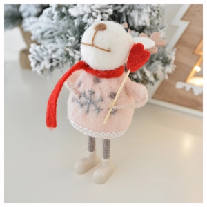 Detail of wool felt Christmas reindeer wearing a pink sweater and red scarf ornament