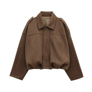 Detailed view of dark brown suede bomber jacket with shoulder epaulets and stitching